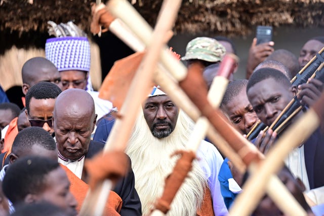 Edward Rukidi Kijanangoma, centre, walks during his coronation as king of Uganda’s traditional Tooro Kingdom