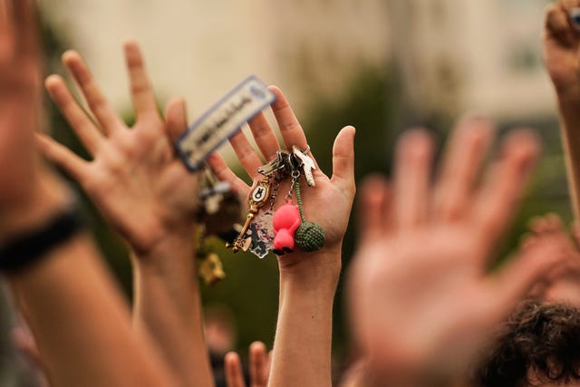 People hold up keys as a sign of protest during a demonstration demanding stronger laws to protect renters in Madrid