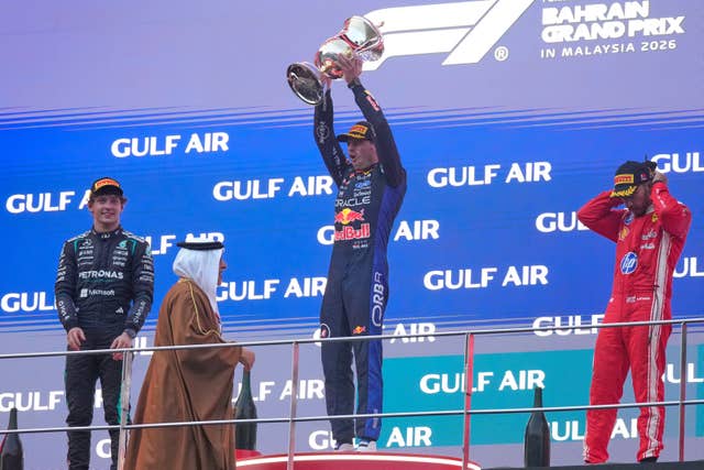 Red Bull driver Max Verstappen of the Netherlands celebrates on the podium flanked by second place Mercedes driver Andrea Kimi Antonelli of Italy, left and third place Ferrari driver Lewis Hamilton of Britain