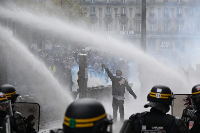 Protesters face police during a demonstration against rising living costs, joining students’ grievances, in Paris