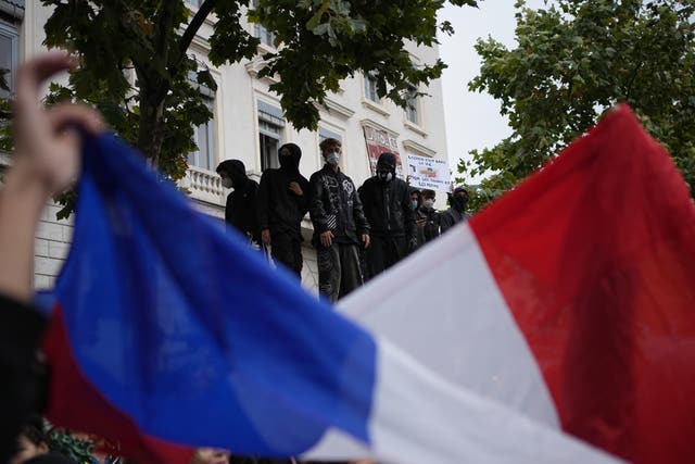 A protesters holds a French flag during a demonstration