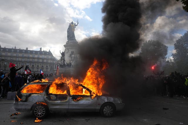 A car burns at Republique square in Paris