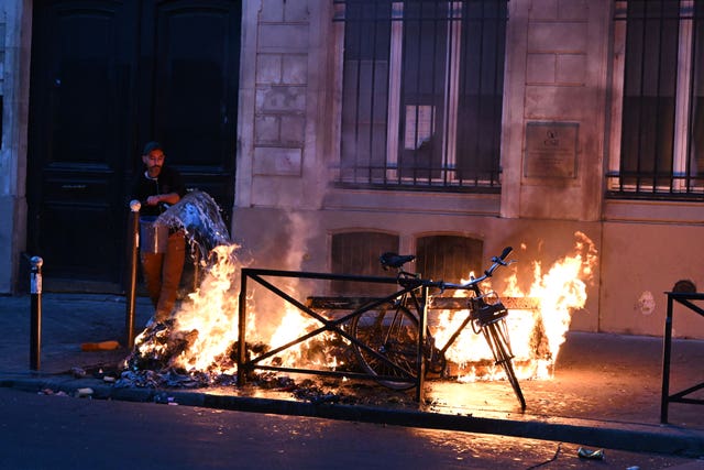 A man tries to extinguish a fire in Paris