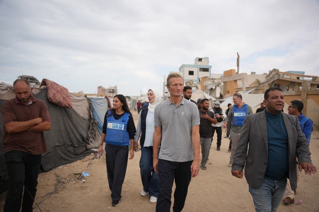 World Food Programme executive director Carl Skau, centre, visiting a camp for displaced Palestinians in Deir al-Balah