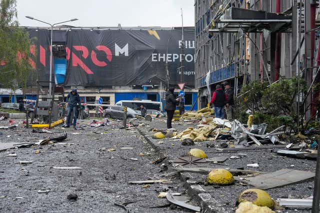 People look at a damaged office centre after a Russian missile attack in central Kyiv, Ukraine