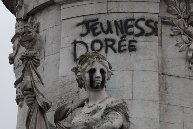 A tag reading 'the golden youth' on the statue of Equality at the Republique square in Paris