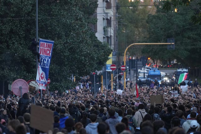 People march through the streets of Milan