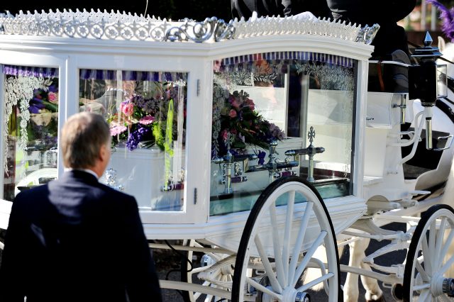 The hearse carrying the coffin of murder victim Hannah Witheridge arrives for her funeral service.