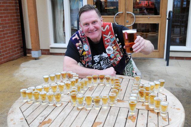 Pete Hill celebrates the Black Country Ale Tairsters visiting their 20,000th pub with a pint of Marston's 61 Deep pale ale