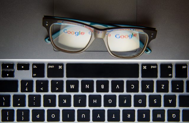 The logo of internet search engine Google reflected in a pair of glasses