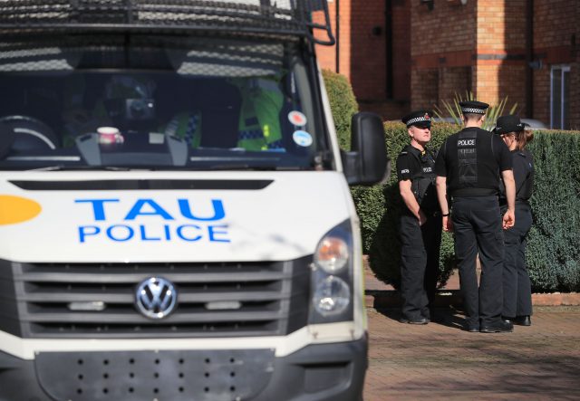 Police pictured outside a property in Didsbury as the inquiry into Wednesday's terror attack in Westminster continues