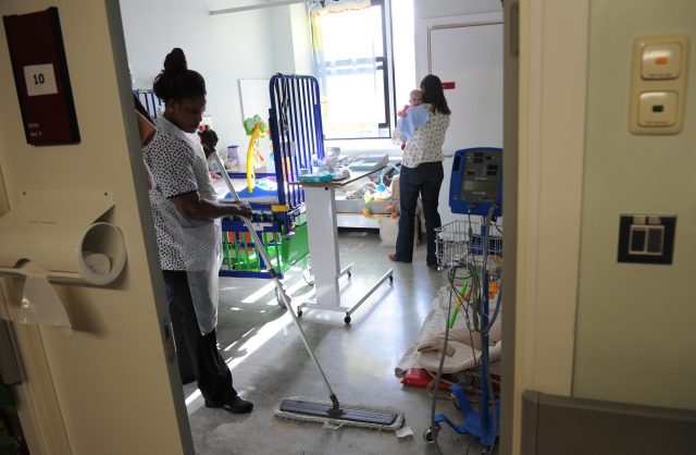 A cleaner and patient with baby at Great Ormond Street Children's Hospital in London