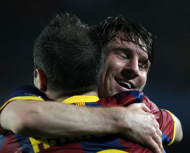 Lionel Messi, right, celebrates with Andres Iniesta, left