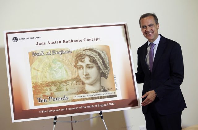 Bank of England governor Mark Carney with the new £10 note featuring Jane Austen (Chris Ratcliffe/PA)