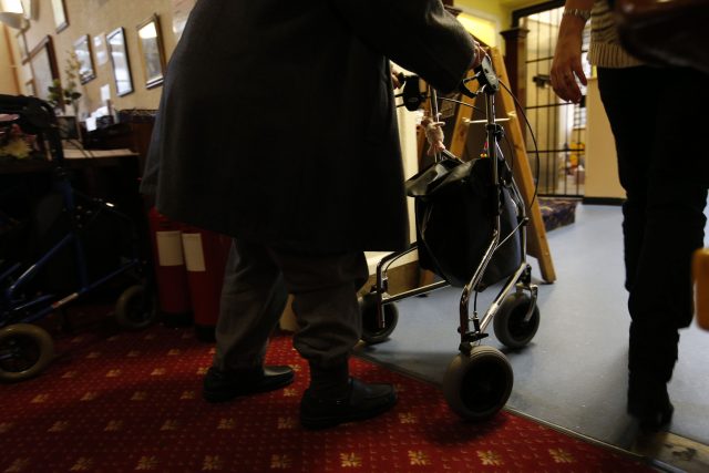 An elderly person with their walker