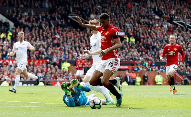 Marcus Rashford goes to ground under Lukasz Fabianski's challenge
