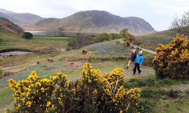 People go for a walk through Rannerdale in the Lake District (Owen Humphreys/PA)
