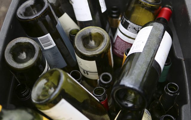 A recycling bin of empty wine bottles