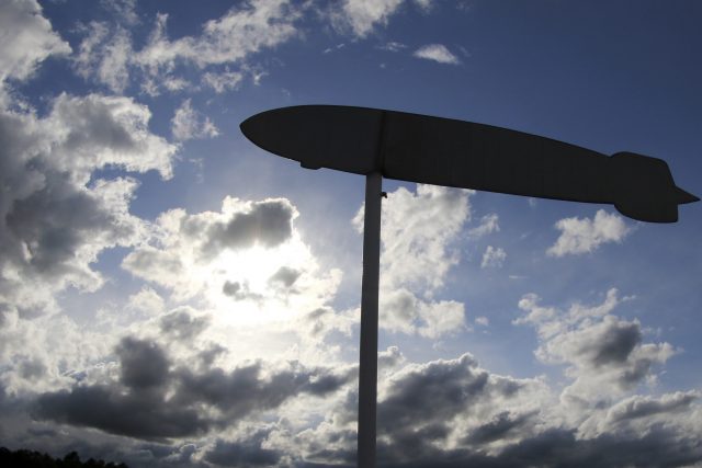 An airship weather vane flies above a memorial honouring the victims of the Hindenburg crash. (AP)