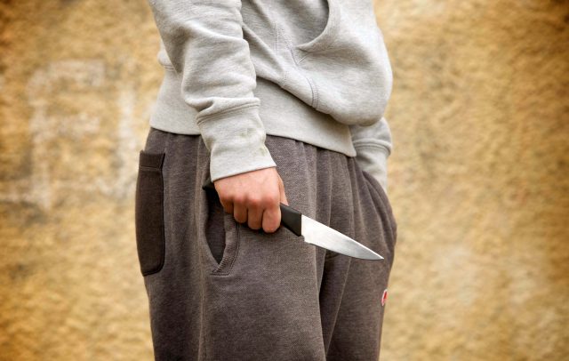 A youth with a knife (Katie Collins/PA)