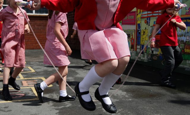 Children skipping in a school playground