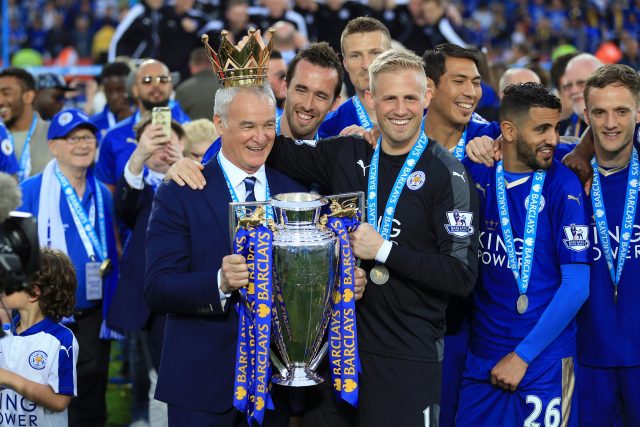Claudio Ranieri holds the Premier League trophy alongside Kasper Schmeichel