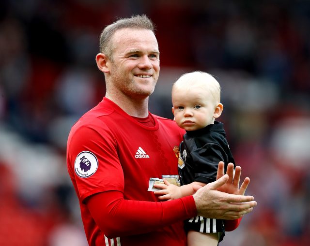 Wayne Rooney carries son Kit around the pitch with him at the end of the game