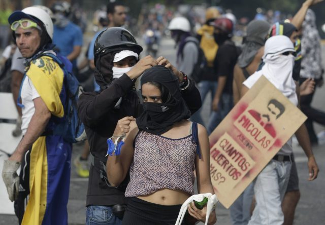 Some demonstrators wore masks (Fernando Llano/AP)