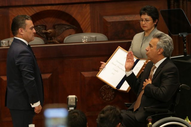 Lenin Moreno holds his hand over his heart as he is sworn in