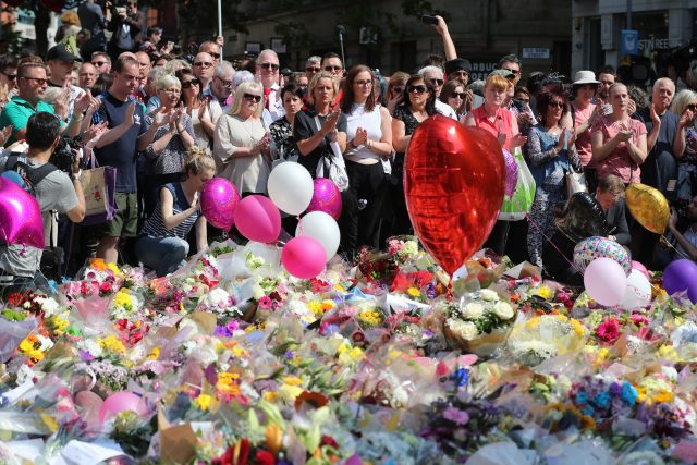 People observe a minute's silence in St Ann's Square (Owen Humphreys/PA)
