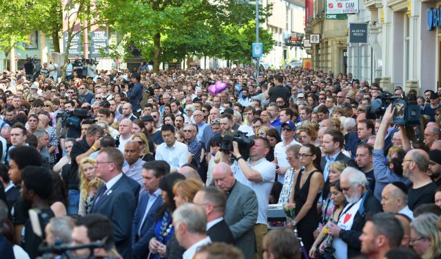 A large number of people observe a minute's silence in St Ann's Square (Ben Birchall/PA)