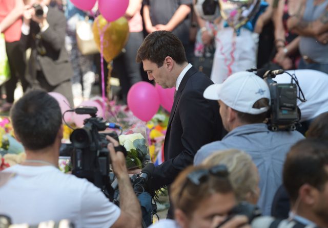 Mayor of Greater Manchester Andy Burnham lays flowers after a minute's silence in St Ann's Square (Ben Birchall/PA)