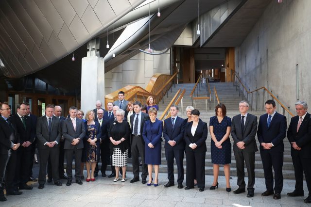 First Minister Nicola Sturgeon joins colleagues in observing a minute's silence in the Garden Lobby of the Scottish Parliament in Edinburgh (Jane Barlow/PA)