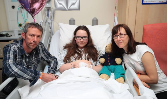 Amy Barlow with her parents Grant and Kathy in the Royal Manchester Children's Hospital (Peter Byrne/PA)