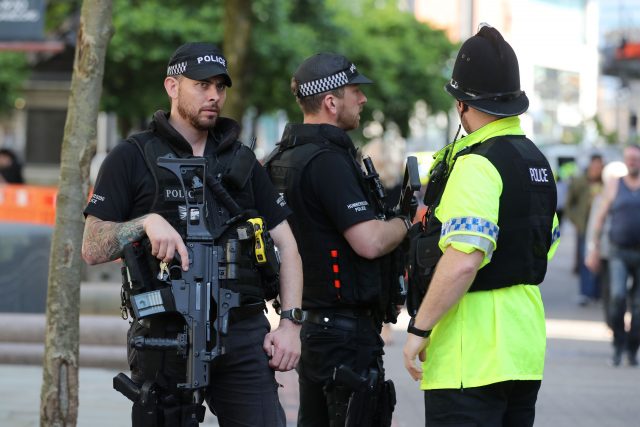 Armed police paused in tribute (Owen Humphreys/PA)