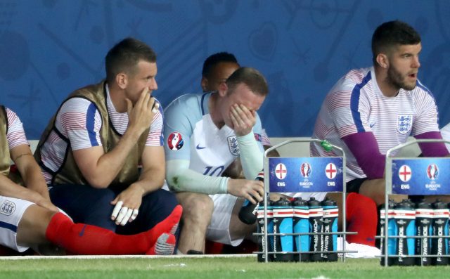 Wayne Rooney sits dejected on the bench for England