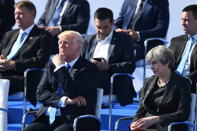 Theresa May at a Nato summit with Donald Trump, left