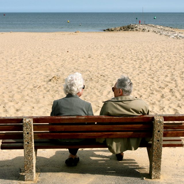 An elderly couple enjoy the sunshine at Sandbanks (Anthony Devlin/PA)