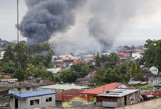 Fires rage at several houses following airstrikes by Philippine Air Force in Marawi city, southern Philippines (Bullit Marquez/AP)