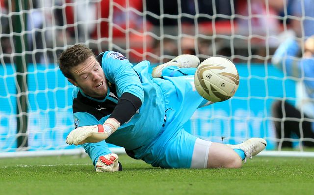 Rotherham United goalkeeper Adam Collin saves the deciding penalty from Leyton Orient's Chris Dagnall in 2014 (Mike Egerton/PA)