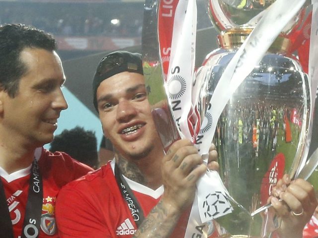 Ederson with the Portuguese league trophy as Julio Cesar watches on (Pedro Rocha/AP)