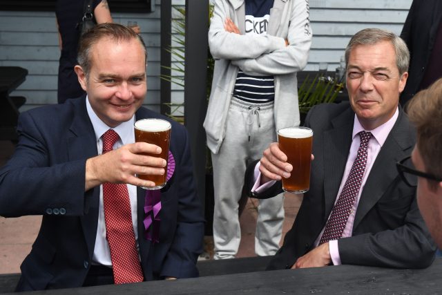 Former Ukip leader Nigel Farage (right) has a pint of beer with the party's local candidate Paul Oakley while on the general election campaign trail in Clacton (Victoria Jones/PA)