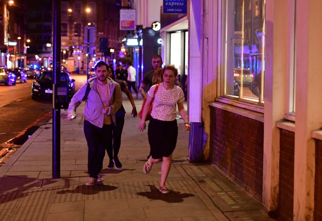 People run down Borough High Street to flee (Dominic Lipinski/PA)