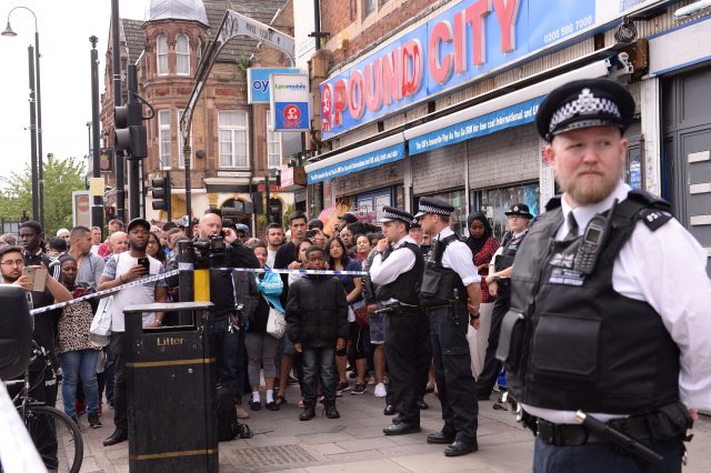 A crowd gathered to watch on Barking Road (Stefan Rousseau/PA)