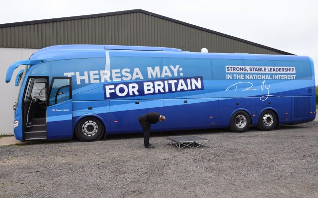 A man inspects the Conservative Party campaign bus (PA)