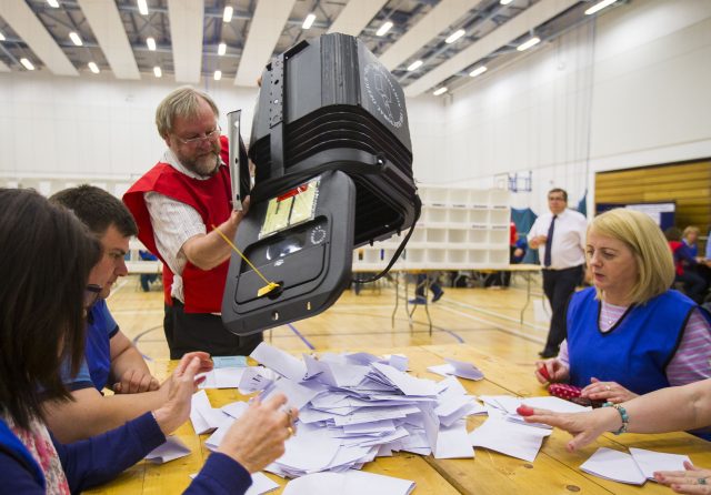 Election staff count ballot papers at Omagh Leisure Complex in Omagh (Liam McBurney//PA)