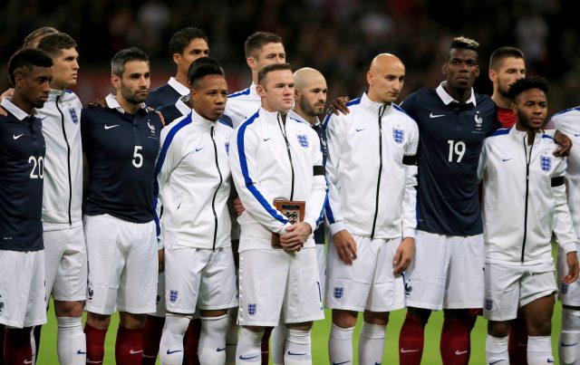 England and France players stand together during a minute's silence