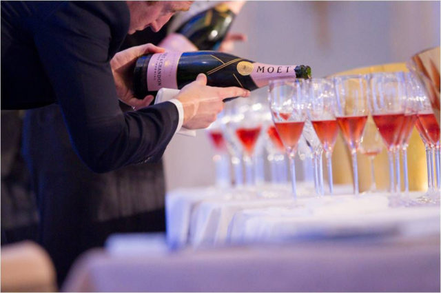 Pic of sommelier pouring rose champagne