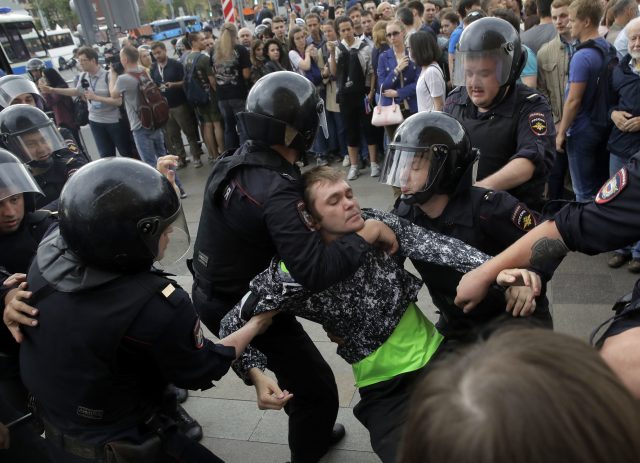 Police arrest a protester in Moscow