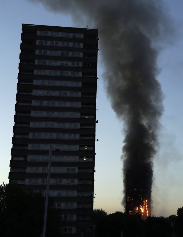 Smoke and flames rise from a building on fire in London (Matt Dunham/AP)